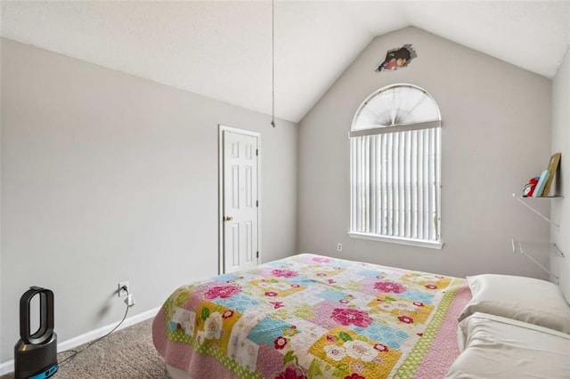 carpeted bedroom with lofted ceiling and baseboards