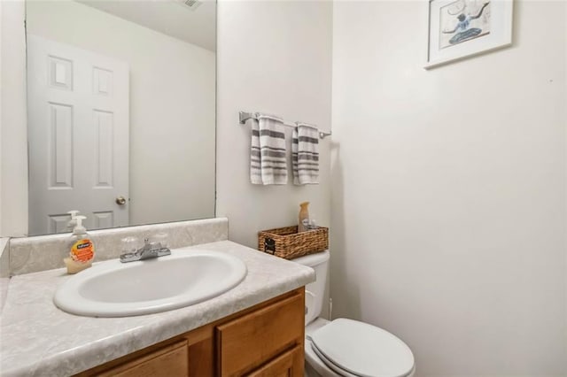 bathroom featuring toilet and vanity