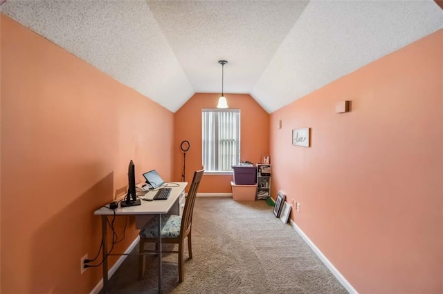 office area featuring lofted ceiling, carpet, baseboards, and a textured ceiling