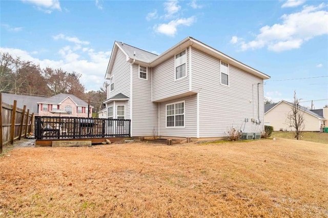 rear view of house featuring a deck, central AC, a yard, and fence