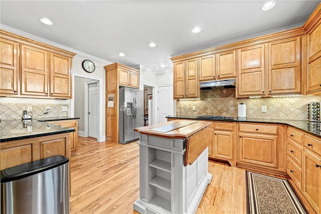 kitchen featuring stainless steel fridge, under cabinet range hood, open shelves, light wood-style flooring, and crown molding