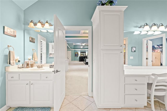 bathroom featuring tile patterned floors, vanity, and vaulted ceiling