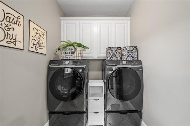 clothes washing area featuring washer and dryer, cabinet space, baseboards, and tile patterned flooring
