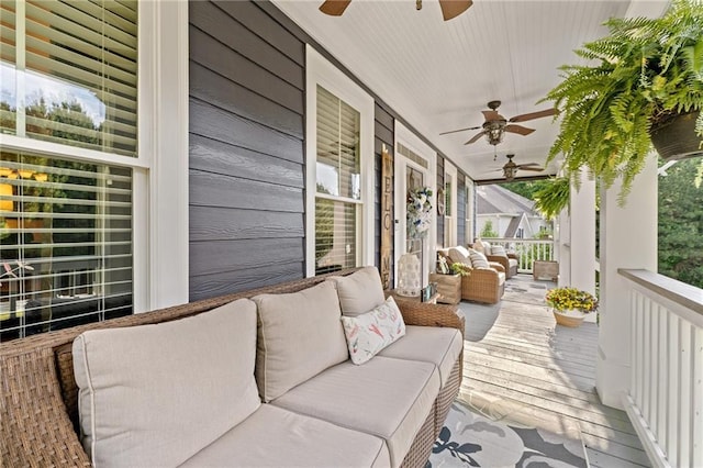 wooden deck with ceiling fan, covered porch, and an outdoor living space