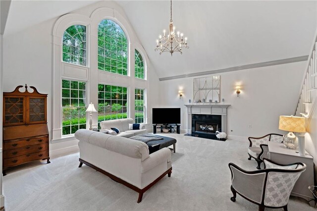 775 Barberry Dr, Milton, GA 30004 - carpeted living area with a chandelier, high vaulted ceiling, a fireplace, and baseboards