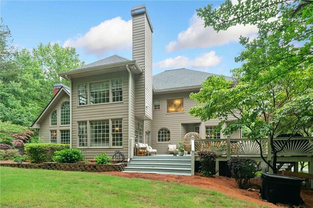 775 Barberry Dr, Milton, GA 30004 - back of property at dusk with a deck, a chimney, and a lawn