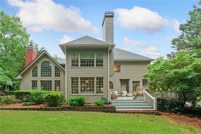 775 Barberry Dr, Milton, GA 30004 - back of property at dusk with a deck, a chimney, and a lawn
