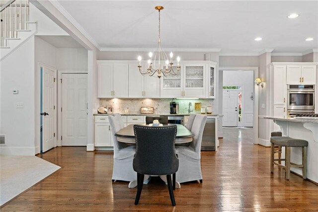 775 Barberry Dr, Milton, GA 30004 - kitchen with stainless steel dishwasher, a sink, white cabinetry, dark wood-style flooring, and decorative backsplash