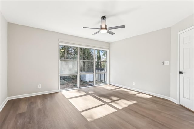 spare room featuring hardwood / wood-style floors and ceiling fan