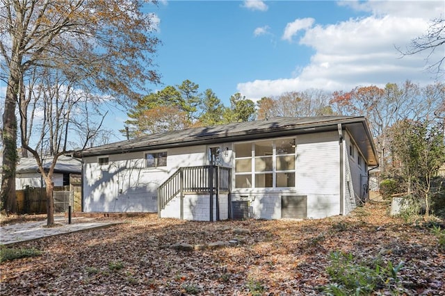 rear view of property featuring central AC unit