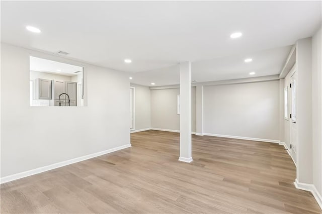 basement featuring light hardwood / wood-style flooring