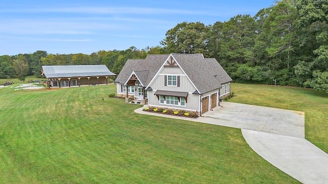 view of front of house featuring a front yard, a porch, and a garage