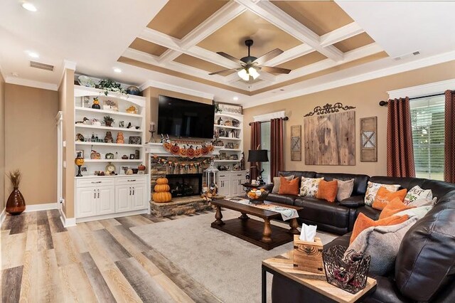 living room featuring coffered ceiling, crown molding, light hardwood / wood-style floors, and ceiling fan