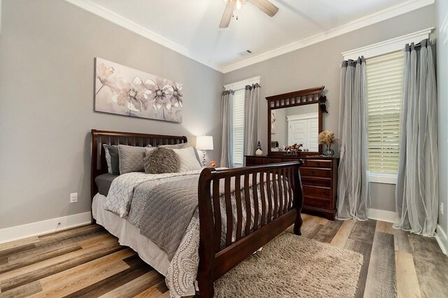 bedroom featuring ceiling fan, hardwood / wood-style flooring, and ornamental molding