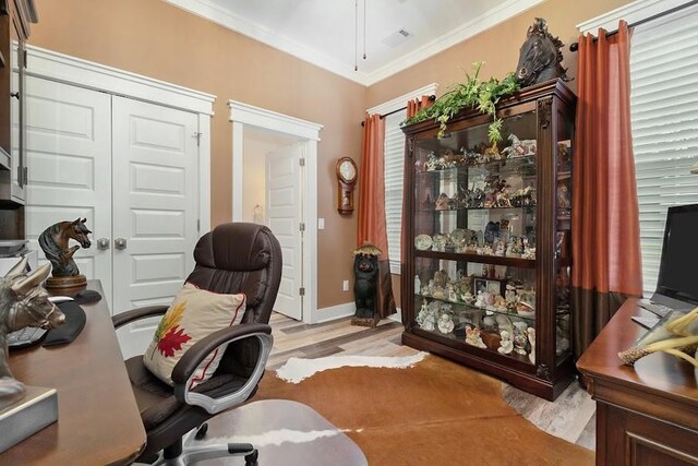 office featuring light wood-type flooring and ornamental molding