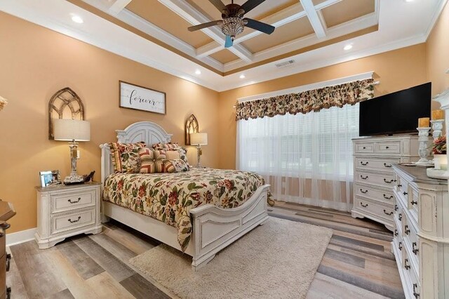 bedroom featuring ceiling fan, beam ceiling, ornamental molding, wood-type flooring, and coffered ceiling