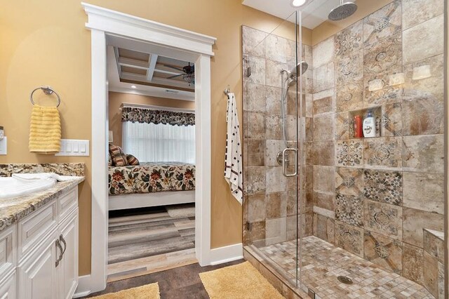 bathroom featuring coffered ceiling, vanity, walk in shower, ceiling fan, and hardwood / wood-style flooring