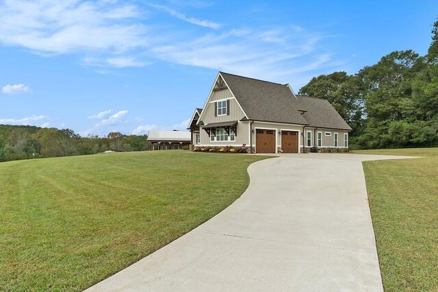 view of front of house featuring a garage and a front lawn