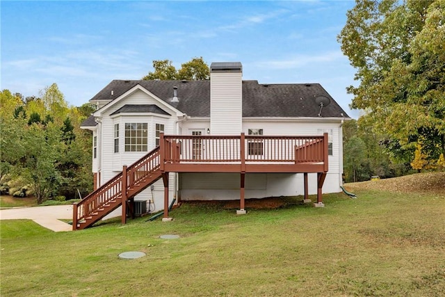 rear view of house with a chimney, a lawn, stairway, cooling unit, and a wooden deck