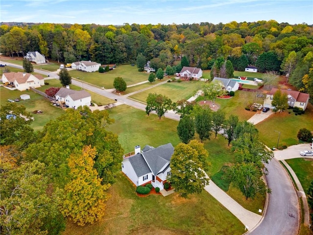 birds eye view of property featuring a wooded view