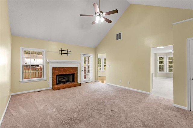 unfurnished living room with high vaulted ceiling, a fireplace, visible vents, and carpet flooring