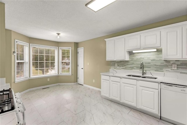 kitchen with white appliances, marble finish floor, decorative backsplash, and a sink