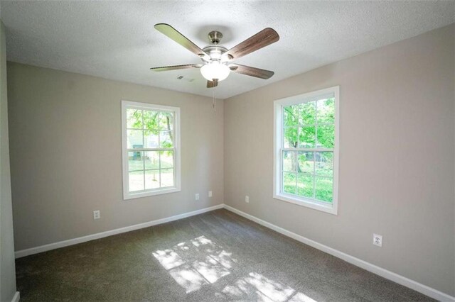 212 Cobb St, Cedartown, GA 30125 - spare room featuring visible vents, baseboards, dark colored carpet, a textured ceiling, and a ceiling fan