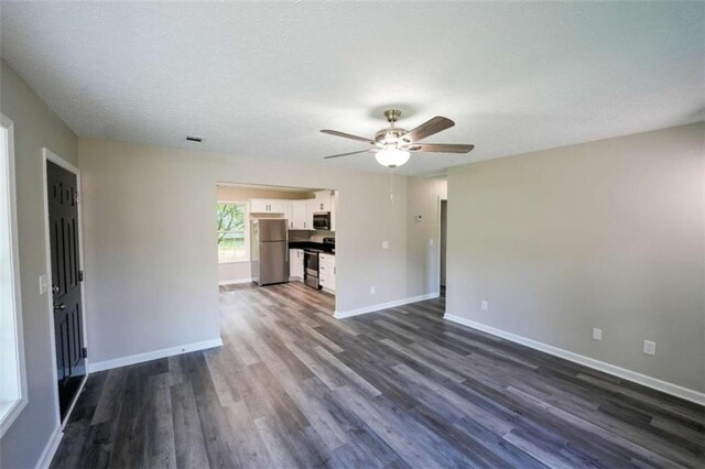 212 Cobb St, Cedartown, GA 30125 - unfurnished living room with baseboards, a ceiling fan, dark wood finished floors, and visible vents