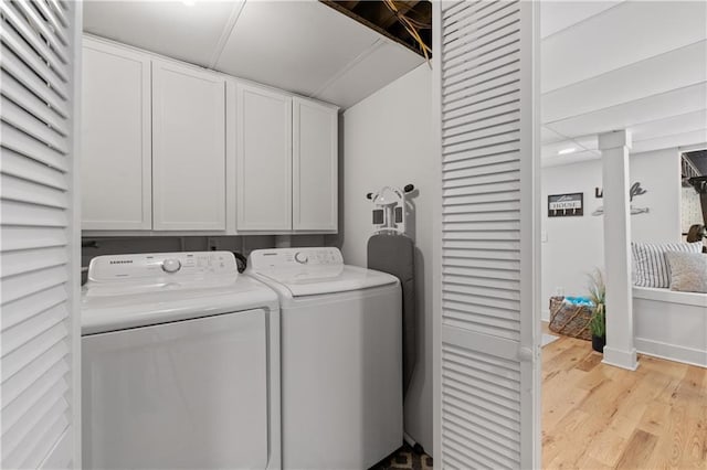 6160 Lake Lanier Heights Rd, Buford, GA 30518 - laundry room featuring washing machine and dryer, cabinet space, and light wood-type flooring