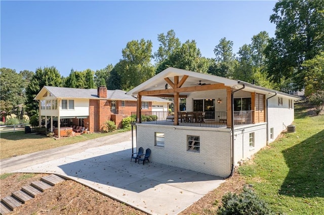 6160 Lake Lanier Heights Rd, Buford, GA 30518 - back of property with a patio, ceiling fan, a lawn, and brick siding