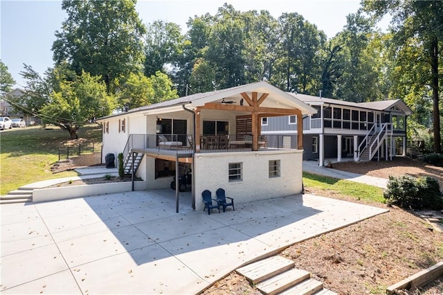 6160 Lake Lanier Heights Rd, Buford, GA 30518 - back of property with stairs, a sunroom, a patio, and brick siding