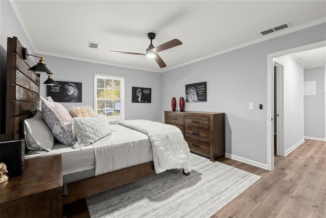 1245 Meriwether St, Griffin, GA 30224 - bedroom with wood finished floors, crown molding, baseboards, and ceiling fan