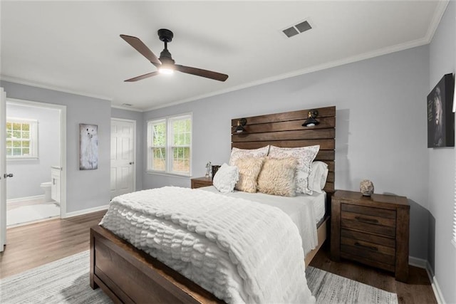 1245 Meriwether St, Griffin, GA 30224 - bedroom with wood finished floors, baseboards, crown molding, ensuite bathroom, and a closet