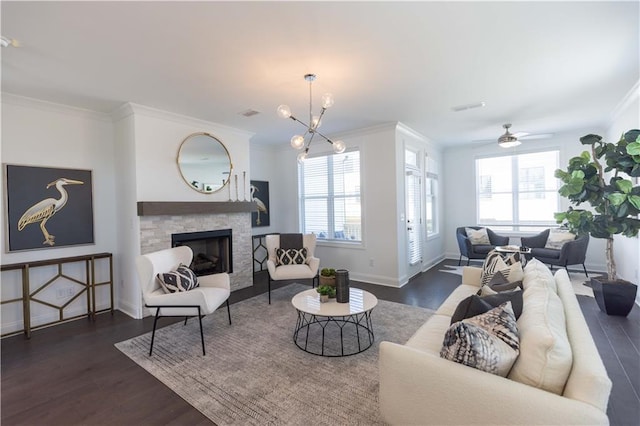 510 Healy Dr Unit 71, Cumming, GA 30040 - living area featuring a stone fireplace, plenty of natural light, wood finished floors, and ornamental molding