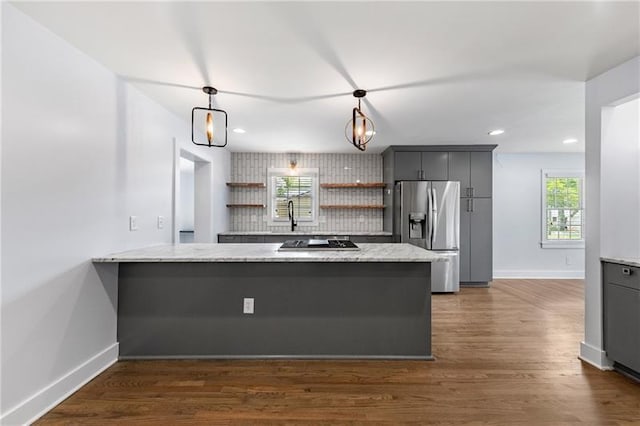957 Sharon Cir SE, Smyrna, GA 30080 - kitchen with stainless steel fridge, baseboards, gray cabinetry, black cooktop, and a peninsula