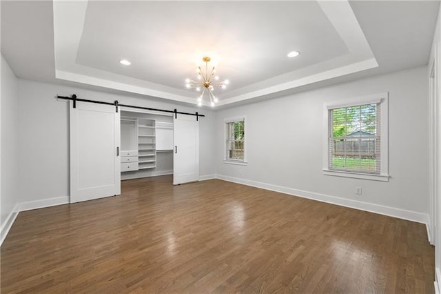 957 Sharon Cir SE, Smyrna, GA 30080 - unfurnished bedroom featuring a barn door, a tray ceiling, a chandelier, and recessed lighting
