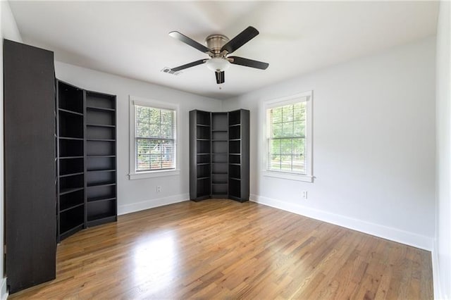 957 Sharon Cir SE, Smyrna, GA 30080 - empty room with plenty of natural light, baseboards, wood finished floors, and a ceiling fan