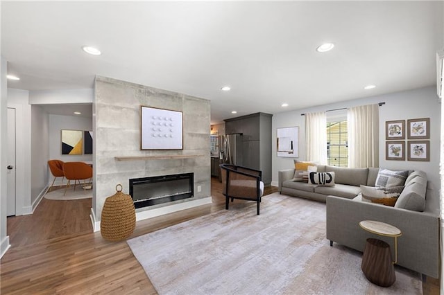 957 Sharon Cir SE, Smyrna, GA 30080 - living room with light wood finished floors, a tile fireplace, recessed lighting, and baseboards