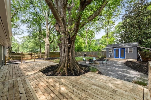 957 Sharon Cir SE, Smyrna, GA 30080 - wooden terrace with a fenced backyard, an outdoor structure, a fire pit, and a patio