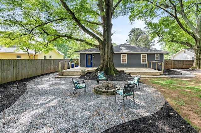 957 Sharon Cir SE, Smyrna, GA 30080 - rear view of house featuring a deck, an outdoor fire pit, a fenced backyard, and a patio area