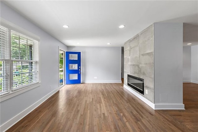 957 Sharon Cir SE, Smyrna, GA 30080 - unfurnished living room with healthy amount of natural light, baseboards, wood finished floors, recessed lighting, and a fireplace