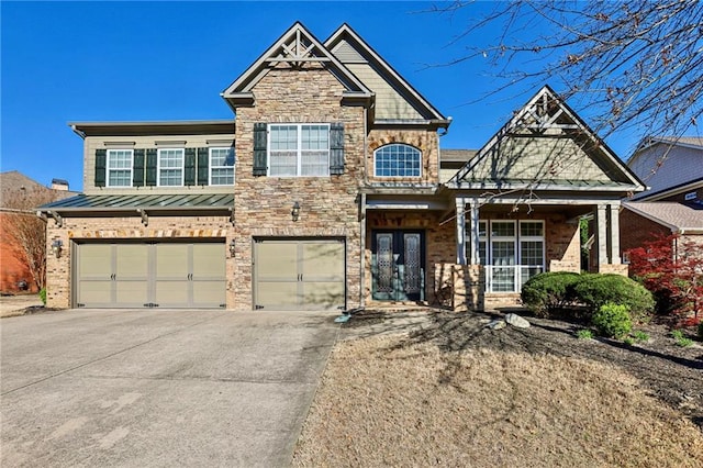 4540 Hastings Dr, Cumming, GA 30041 - view of front of property with driveway, an attached garage, a standing seam roof, stone siding, and a porch