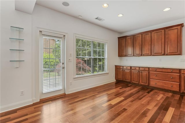 4540 Hastings Dr, Cumming, GA 30041 - kitchen with light countertops, dark wood-style floors, brown cabinetry, recessed lighting, and baseboards