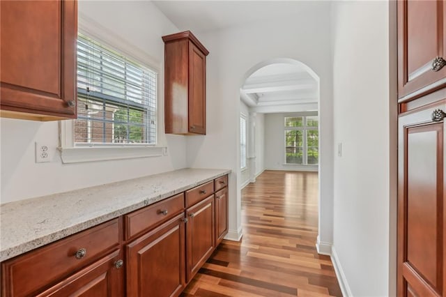 4540 Hastings Dr, Cumming, GA 30041 - hallway with light wood-style flooring, arched walkways, and baseboards