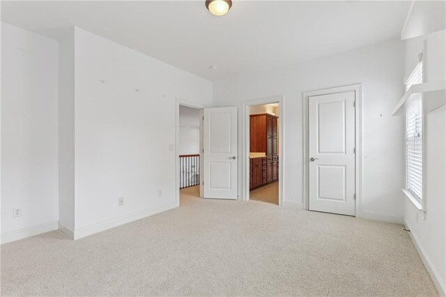 4540 Hastings Dr, Cumming, GA 30041 - unfurnished bedroom with light carpet, baseboards, and connected bathroom