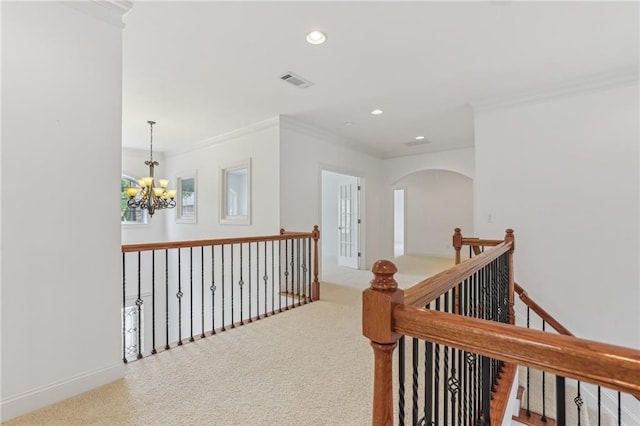 4540 Hastings Dr, Cumming, GA 30041 - hallway featuring a chandelier, ornamental molding, arched walkways, an upstairs landing, and recessed lighting