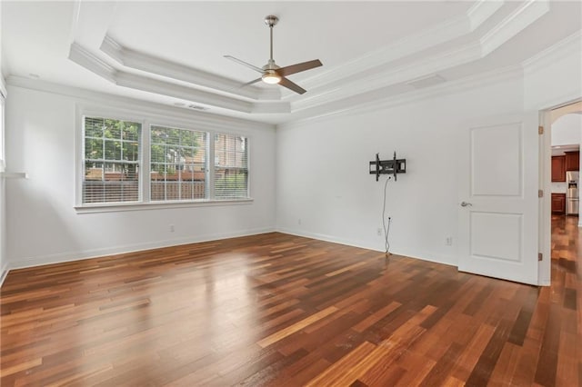 4540 Hastings Dr, Cumming, GA 30041 - empty room featuring a ceiling fan, crown molding, a tray ceiling, wood finished floors, and arched walkways
