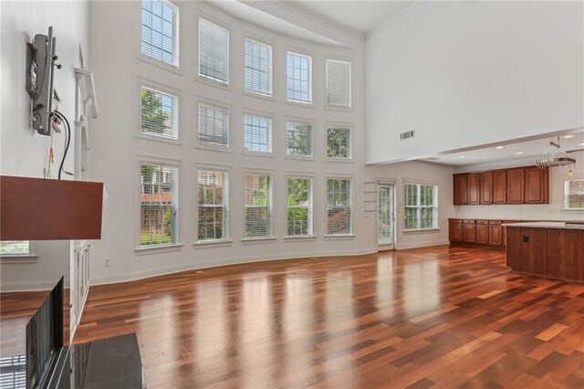 4540 Hastings Dr, Cumming, GA 30041 - unfurnished living room featuring a high ceiling, dark wood-style floors, and baseboards