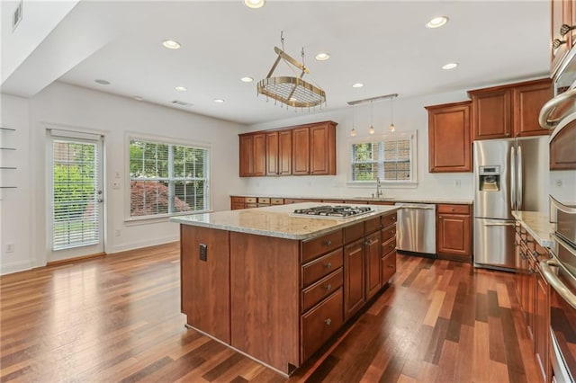 4540 Hastings Dr, Cumming, GA 30041 - kitchen with appliances with stainless steel finishes, dark wood-style floors, a sink, a center island, and recessed lighting