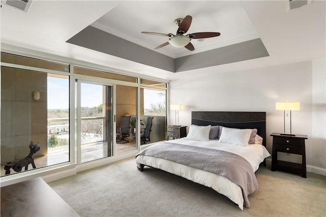 bedroom with access to exterior, visible vents, a tray ceiling, and light carpet